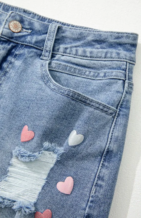 The Heartbreaker Skirt – Distressed Raw Hem Denim with Heart Detail